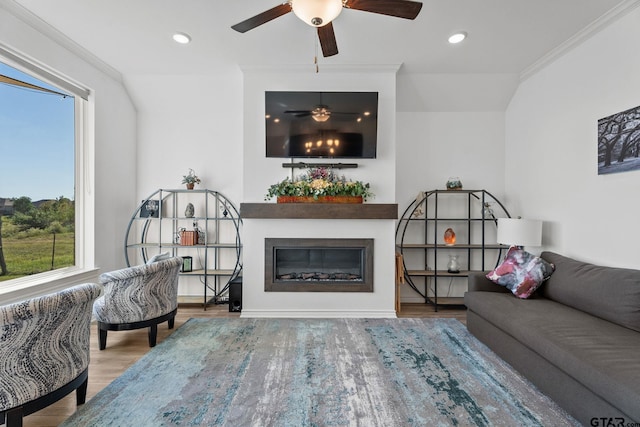 living room featuring a healthy amount of sunlight, hardwood / wood-style floors, and ornamental molding