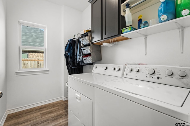 laundry area with washer and dryer, cabinets, and dark hardwood / wood-style flooring