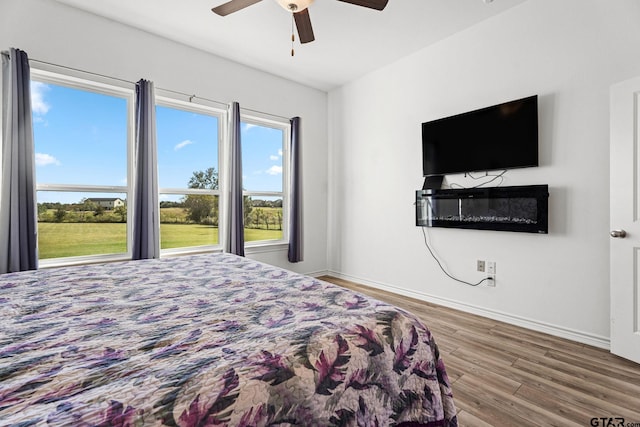 bedroom with hardwood / wood-style flooring and ceiling fan