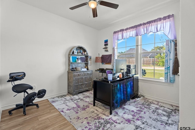 home office featuring ceiling fan and light hardwood / wood-style flooring