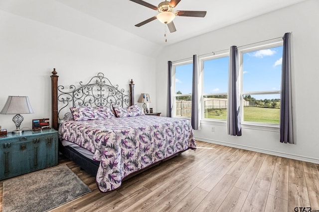 bedroom featuring vaulted ceiling, ceiling fan, and hardwood / wood-style floors