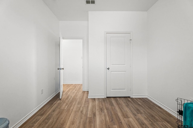 unfurnished bedroom featuring hardwood / wood-style flooring