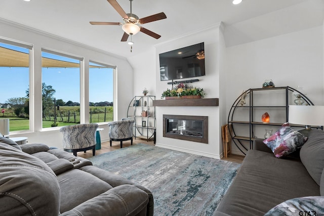 living room with ornamental molding, ceiling fan, and hardwood / wood-style flooring