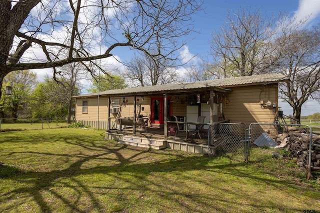 rear view of property featuring a lawn