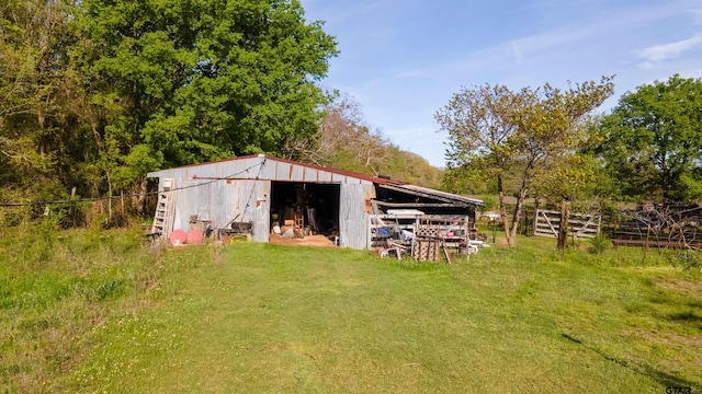 view of outbuilding featuring a yard