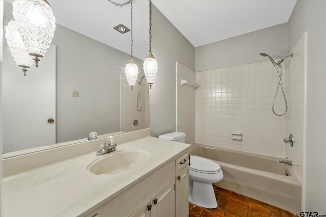 full bathroom featuring toilet, vanity, and tiled shower / bath