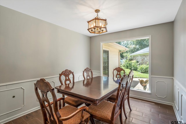 dining area featuring an inviting chandelier, dark hardwood / wood-style floors, and plenty of natural light