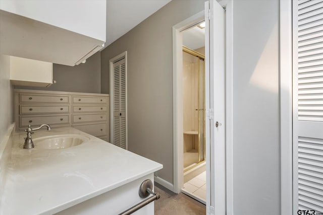 bathroom with vanity and a shower with door