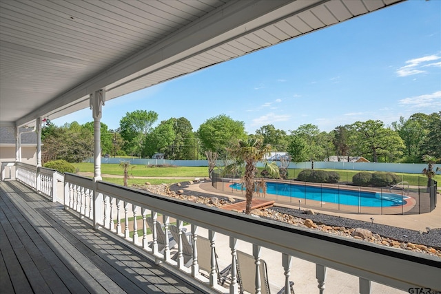 wooden deck with a fenced in pool