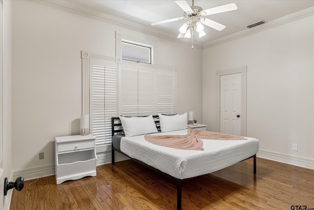 bedroom featuring ceiling fan, ornamental molding, and hardwood / wood-style flooring