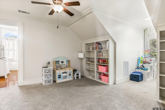 game room featuring ceiling fan, carpet, ornamental molding, and vaulted ceiling