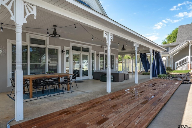 deck featuring ceiling fan, an outdoor hangout area, french doors, and a patio area