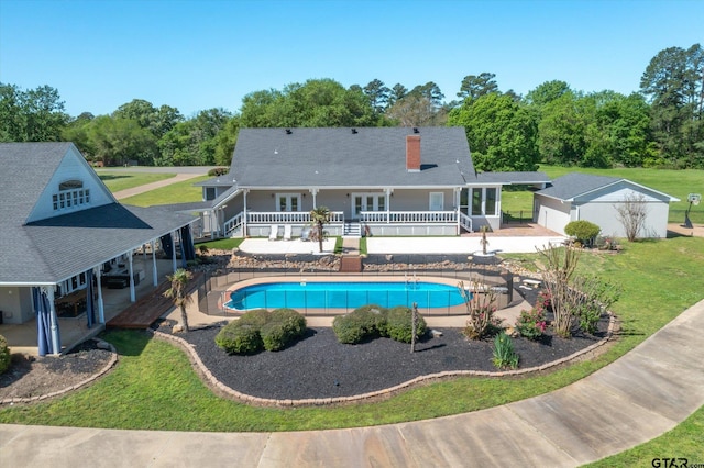 view of pool featuring a lawn and a patio