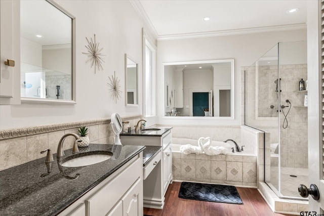 bathroom with vanity, independent shower and bath, crown molding, and hardwood / wood-style flooring