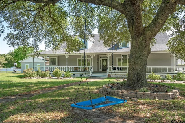 back of house with covered porch and a yard