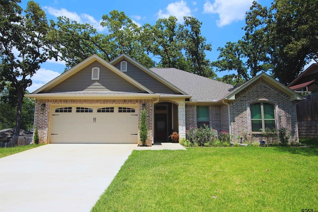 1700 Easy St, Tyler, TX 75703 - view of front of home with brick siding, an attached garage, and a front lawn