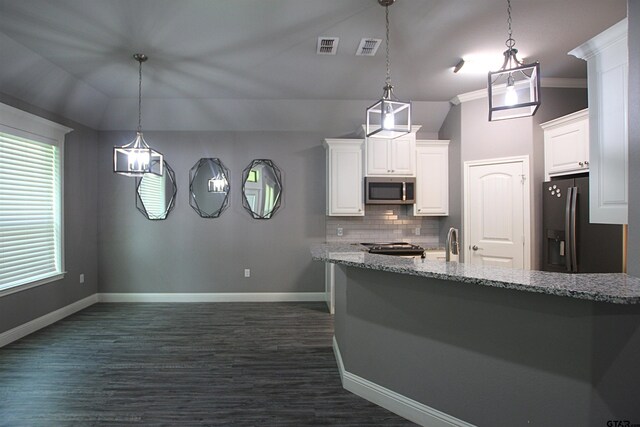 1700 Easy St, Tyler, TX 75703 - kitchen with stainless steel microwave, lofted ceiling, black refrigerator with ice dispenser, white cabinetry, and tasteful backsplash
