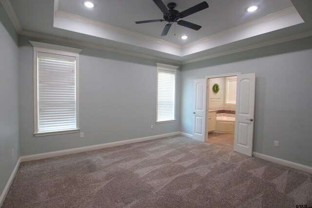 1700 Easy St, Tyler, TX 75703 - unfurnished bedroom featuring a raised ceiling, ornamental molding, light carpet, recessed lighting, and ensuite bathroom