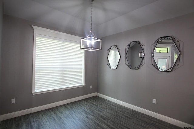1700 Easy St, Tyler, TX 75703 - unfurnished room with dark wood-type flooring and a chandelier
