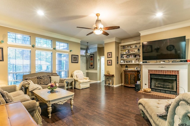 living room featuring dark wood-type flooring, a textured ceiling, ceiling fan, crown molding, and a fireplace