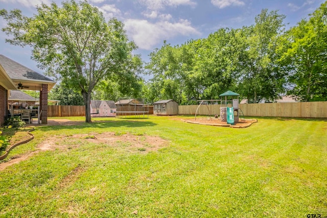 view of yard featuring a shed and a playground