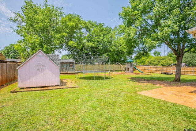 view of yard with a storage unit, a playground, and a trampoline