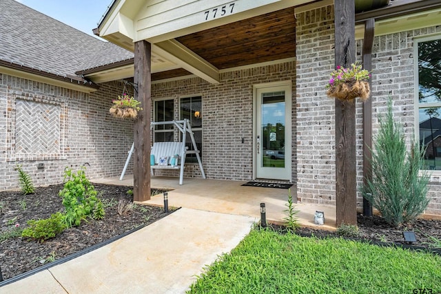 7757 Freestone Dr, Bullard, TX 75757 - entrance to property with brick siding, a shingled roof, and a patio