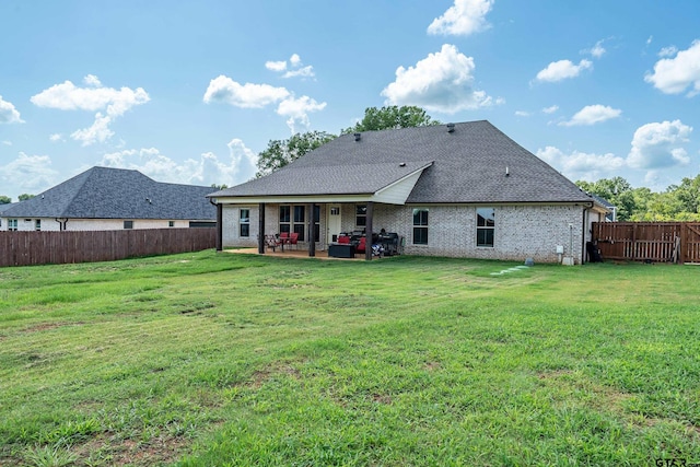 7757 Freestone Dr, Bullard, TX 75757 - back of property featuring a patio area, a fenced backyard, brick siding, and a shingled roof