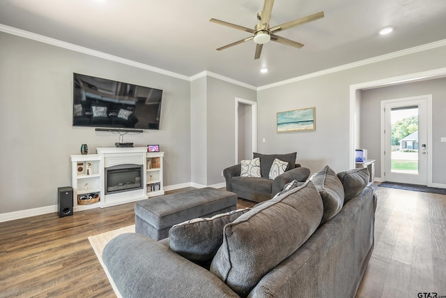 7757 Freestone Dr, Bullard, TX 75757 - living room featuring wood finished floors, a ceiling fan, ornamental molding, a fireplace with raised hearth, and recessed lighting
