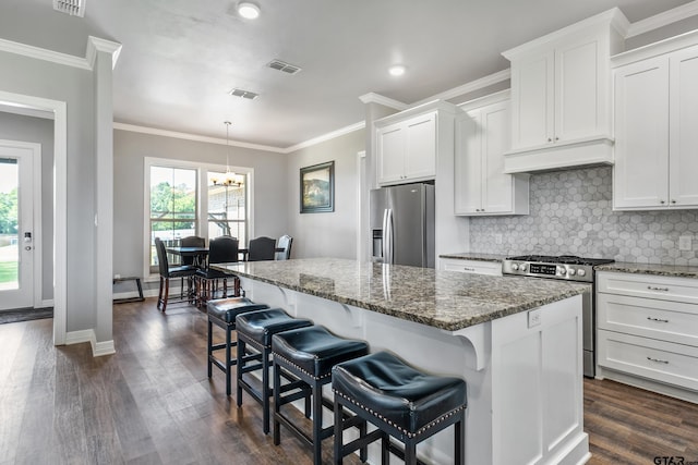7757 Freestone Dr, Bullard, TX 75757 - kitchen with appliances with stainless steel finishes, premium range hood, a kitchen island, dark stone counters, and crown molding