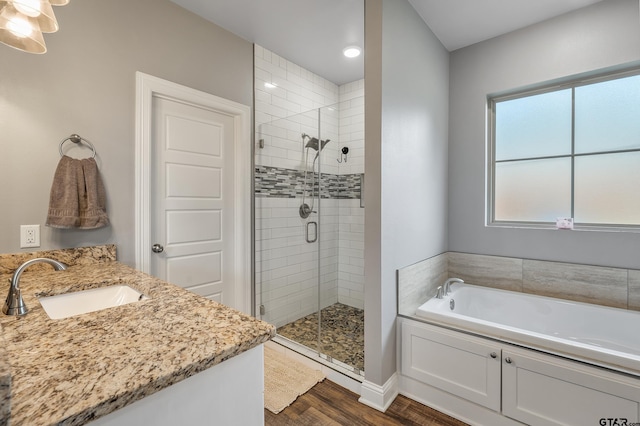 7757 Freestone Dr, Bullard, TX 75757 - bathroom with a shower stall, a bath, wood finished floors, vanity, and recessed lighting
