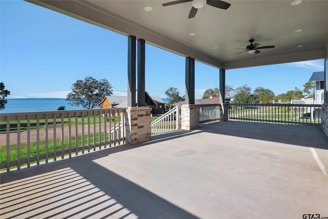 view of patio featuring a ceiling fan and a water view