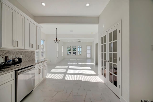 kitchen with tasteful backsplash, light stone countertops, marble finish floor, french doors, and stainless steel dishwasher