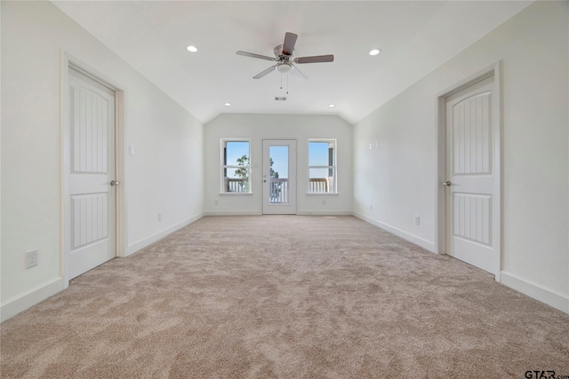 empty room with lofted ceiling, recessed lighting, carpet floors, a ceiling fan, and baseboards