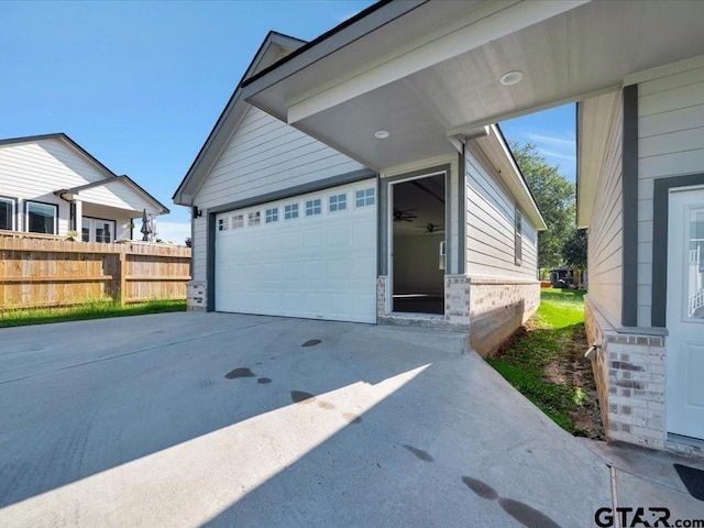 garage with driveway and fence