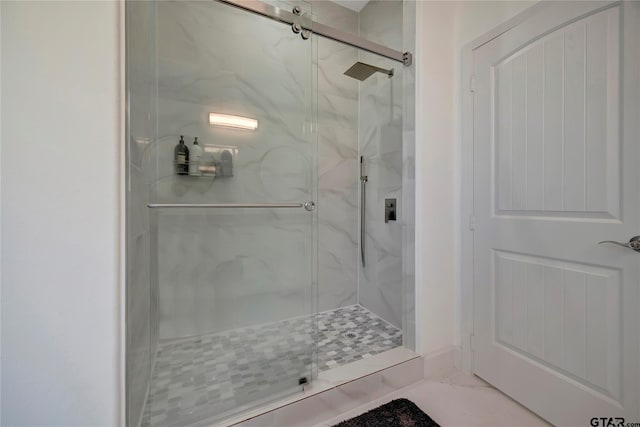 bathroom with marble finish floor and a marble finish shower