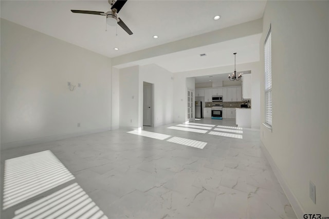 unfurnished living room featuring recessed lighting, marble finish floor, baseboards, and ceiling fan with notable chandelier