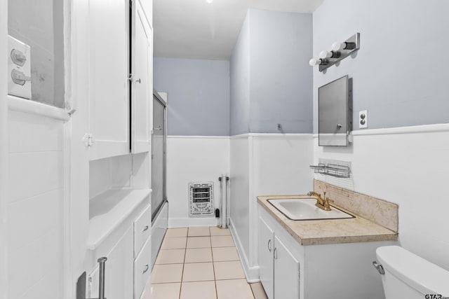 full bathroom with vanity, toilet, a wainscoted wall, and tile patterned floors