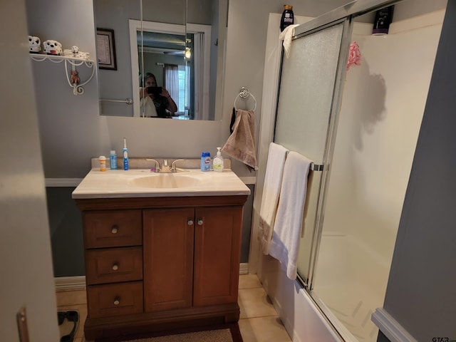 bathroom featuring bath / shower combo with glass door, vanity, and tile patterned flooring