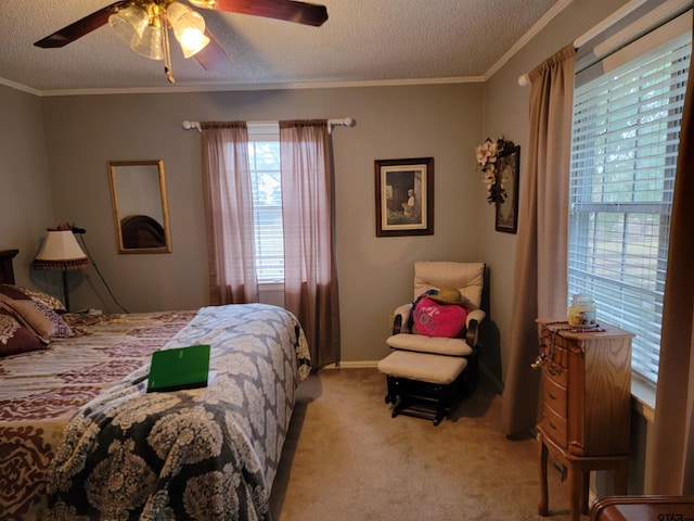 bedroom with a textured ceiling, light colored carpet, ceiling fan, and crown molding