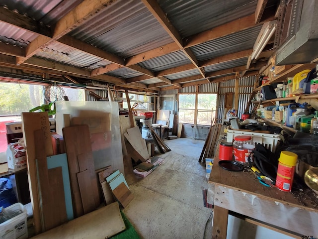 misc room with vaulted ceiling and concrete floors