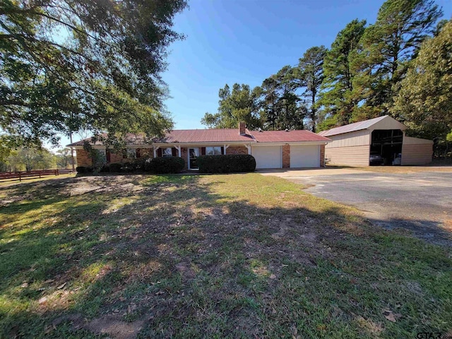 ranch-style home with a garage, a front lawn, and a carport