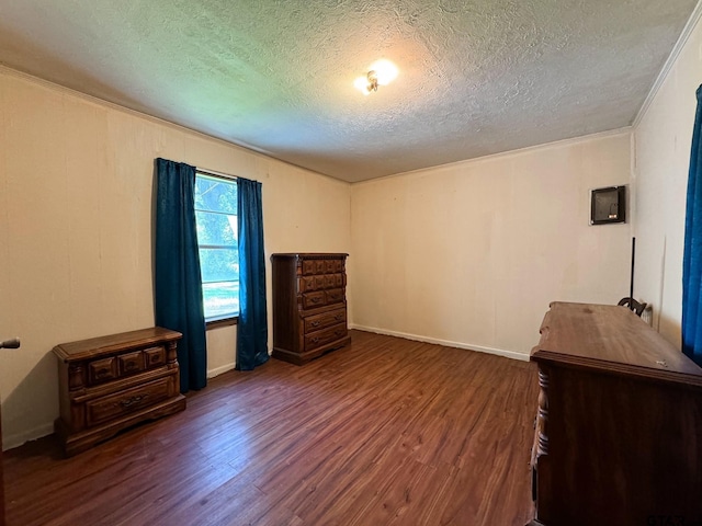 interior space featuring ornamental molding, dark hardwood / wood-style flooring, and a textured ceiling