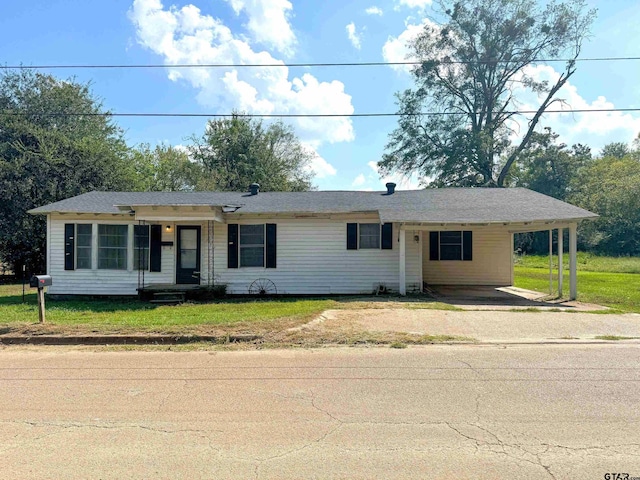 ranch-style house with a front lawn and a carport