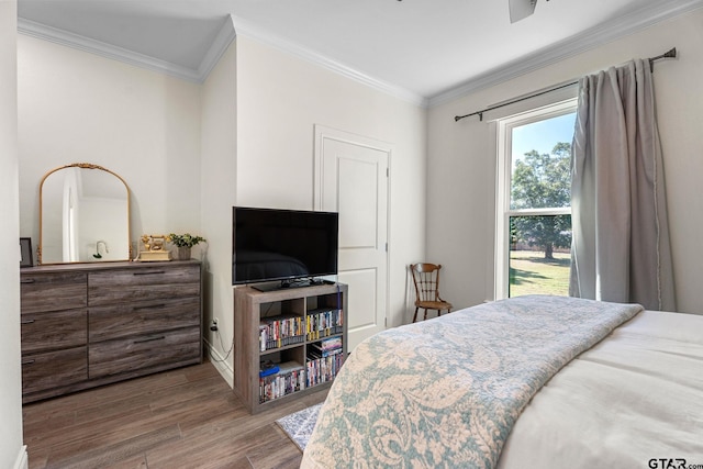 bedroom with hardwood / wood-style floors and ornamental molding