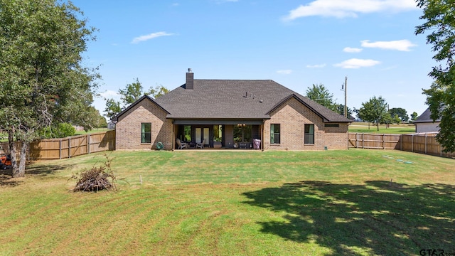 back of house featuring a yard and a patio area