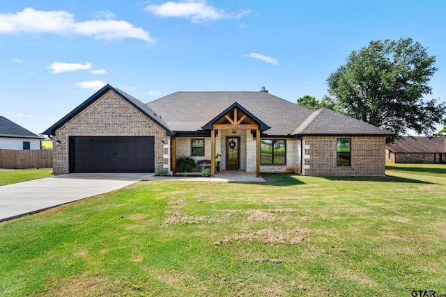 view of front of house featuring a garage and a front lawn