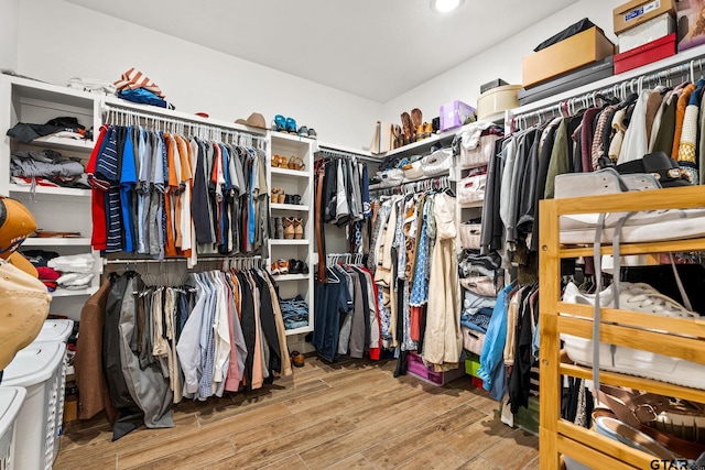 walk in closet with hardwood / wood-style floors