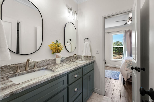 bathroom with hardwood / wood-style floors, vanity, ceiling fan, and crown molding