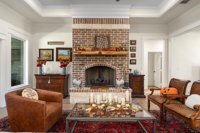 living room with a fireplace, wood-type flooring, and crown molding